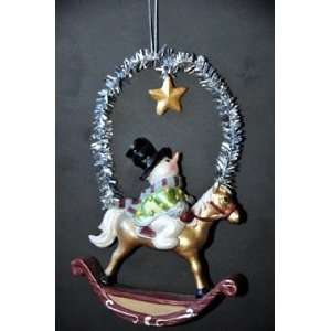   Holiday Ornament in Frosty Wintery Colors. Snowman on Rocking Horse