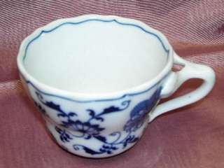   the cup has the unusual handle which is characteristic of this pattern