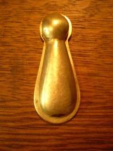This is a gorgeous hidden key hole cover. It is shaped like a tassel 