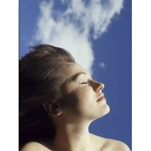  Young Woman Profiled Against a Cloud Filled Sky on a Sunny 