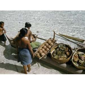  Women Unload Food for a Wedding Feast from an Outrigger 