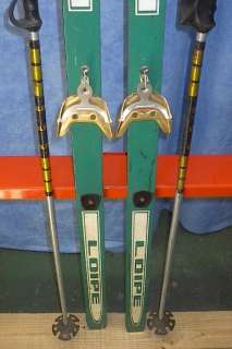 The skis are signed SKAN. The skis are made of wood. Measures 66 