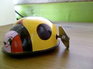 Old Made in Japan Wind Up Tin Toy Beetle with logo  